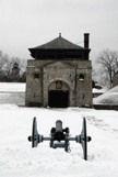 Ft Niagara weapons house with a cannon in front during the winter